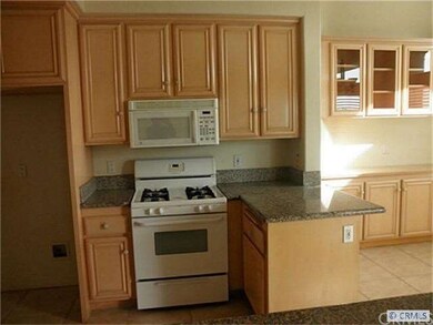 Remodeled kitchen with granite counters, gas stove