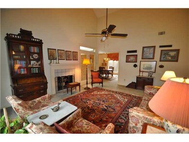 This spacious great room has a vaulted ceiling, wo
