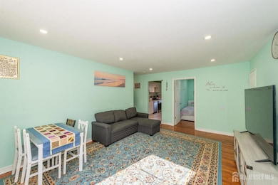 living area with wood finished floors and recessed lighting