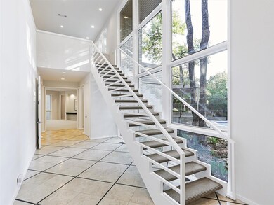 The stairway greets you with wall of windows and a