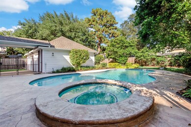 The detached 3 car garage sits off to the side offering a place for beautiful landscaping along the garage wall.  There's green space behind the pool and the garage.