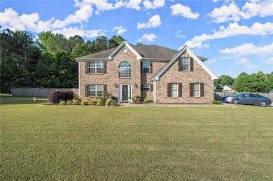 View of front of house featuring fence, brick sidi