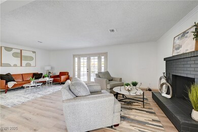 Living area featuring a fireplace, a textured ceil