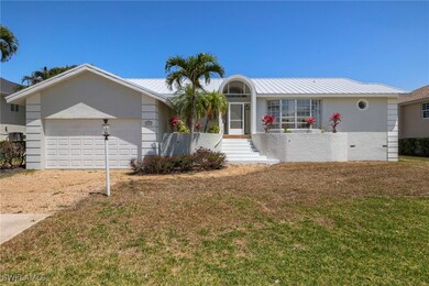 Single story home featuring a garage, a front yard