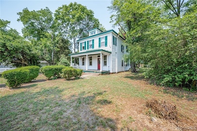 View of front of home featuring covered porch and a front yard