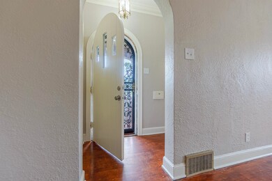 Entrance foyer with ornamental molding and dark ha
