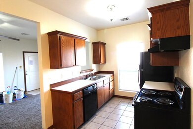 Kitchen featuring range with electric stovetop, si