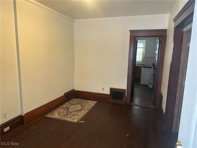 Unfurnished room featuring dark wood finished floors