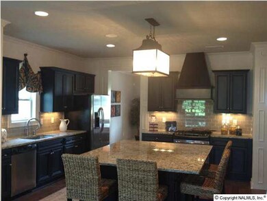 Oversized island kitchen is perfect for gathering around.