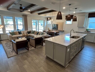 Kitchen featuring dishwasher, an island with sink,