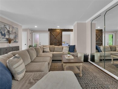 Living room featuring carpet flooring, crown moldi