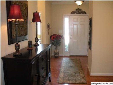 Entry has hardwood floors, coat closet, and divide