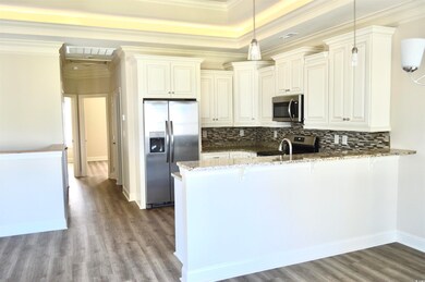 Kitchen featuring hanging light fixtures, tasteful