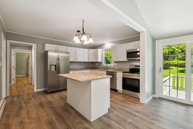 Beautifully remodeled kitchen with a slider leading to the spacious deck and backyard
