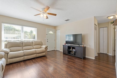 Living room has a big picture window to light up the room making it bright and cheerful.