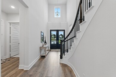 The entryway features  elegant glass double doors