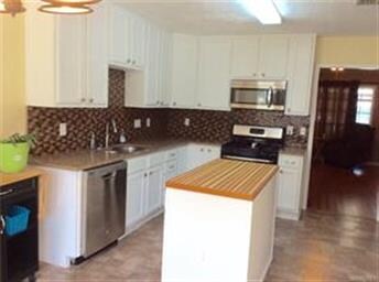 Stainless steel appliances plus a large island.  P