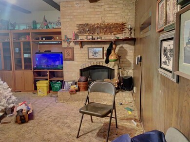 Carpeted living area featuring wooden walls and a 