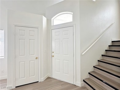 Entryway featuring light wood-type flooring and stairway