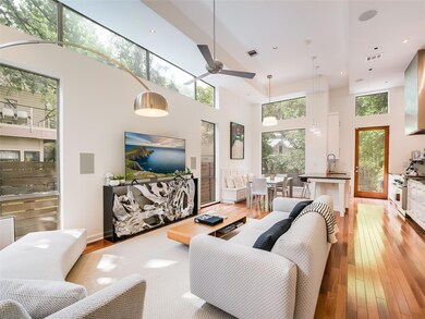Living room featuring a high ceiling, a ceiling f