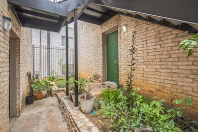View of exterior entry featuring brick siding