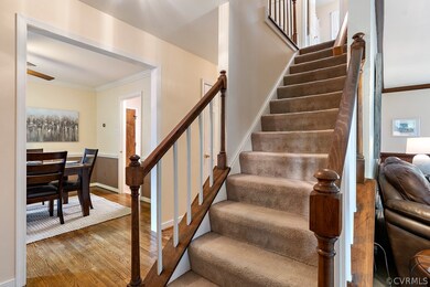 Staircase between the foyer, dining room and famil