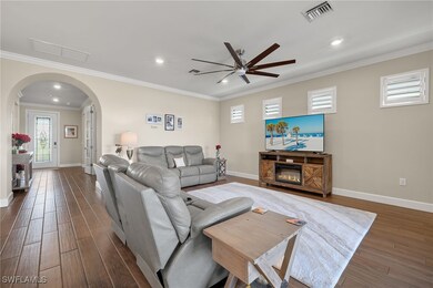 Living room featuring ceiling fan, dark hardwood /