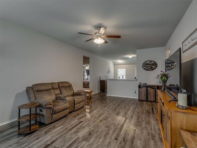 Living area featuring ceiling fan and wood finished floors