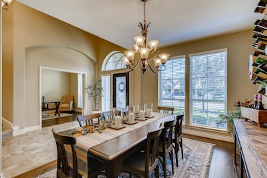 Formal dining room with wood floors. A butler's pantry connects the formal dining room and the kitchen.