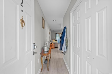 Hall with light wood-type flooring, baseboards, and recessed lighting