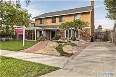 Front of home shows driveway going back to the gar