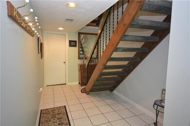 Ceramic tile entry. Door to laundry and storage at