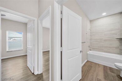 Bathroom with vaulted ceiling, toilet, tiled showe