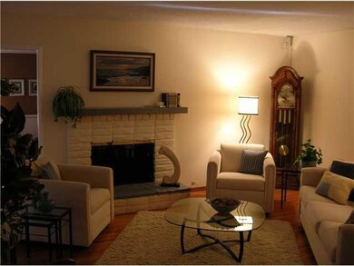 Living Room with Fireplace and Beautiful Original Hardwood Flooring