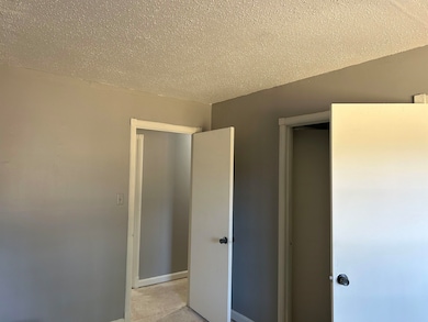 Unfurnished bedroom featuring a textured ceiling