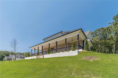 Back of house featuring a lawn, brick siding, and a porch