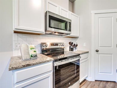 Single story home with brick siding, driveway, and