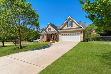 Craftsman house with fence, covered porch, concret