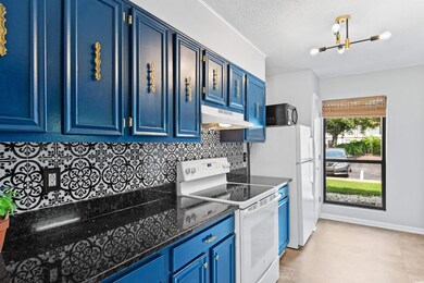 Kitchen with light tile patterned floors, decorati