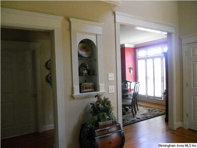 Built in shelves, hardwood floors, open casings an