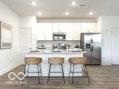Quartz countertops with stainless steel appliances.