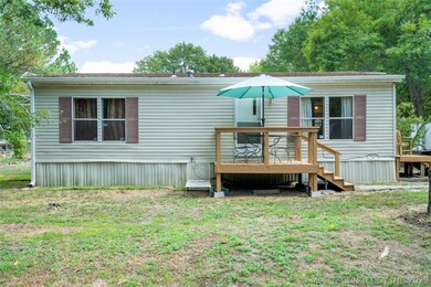 Rear patio with enough room to sit - keep an eye o