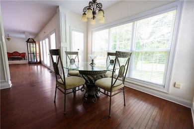 Dining space with a chandelier and dark wood finished floors
