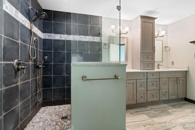 Primary bath on main with large walk in tile shower and double vanity