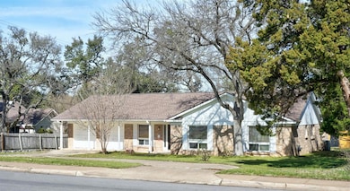 View of front of property with a garage, brick si