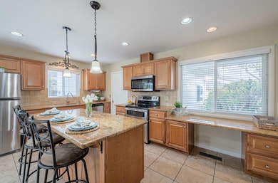 Kitchen has added recessed & pendant lighting  with double pane windows it all up