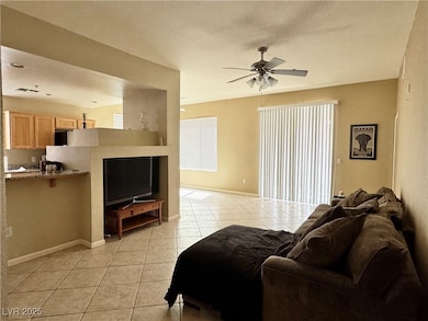 Living area with light diagonal set tile floors, c