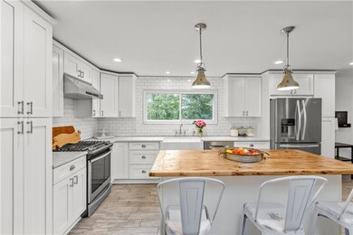 Stunning white kitchen with quartz countertops, ti