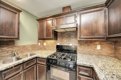 The updated kitchen features granite countertops,