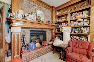 Sitting room with carpet floors, a fireplace, and 